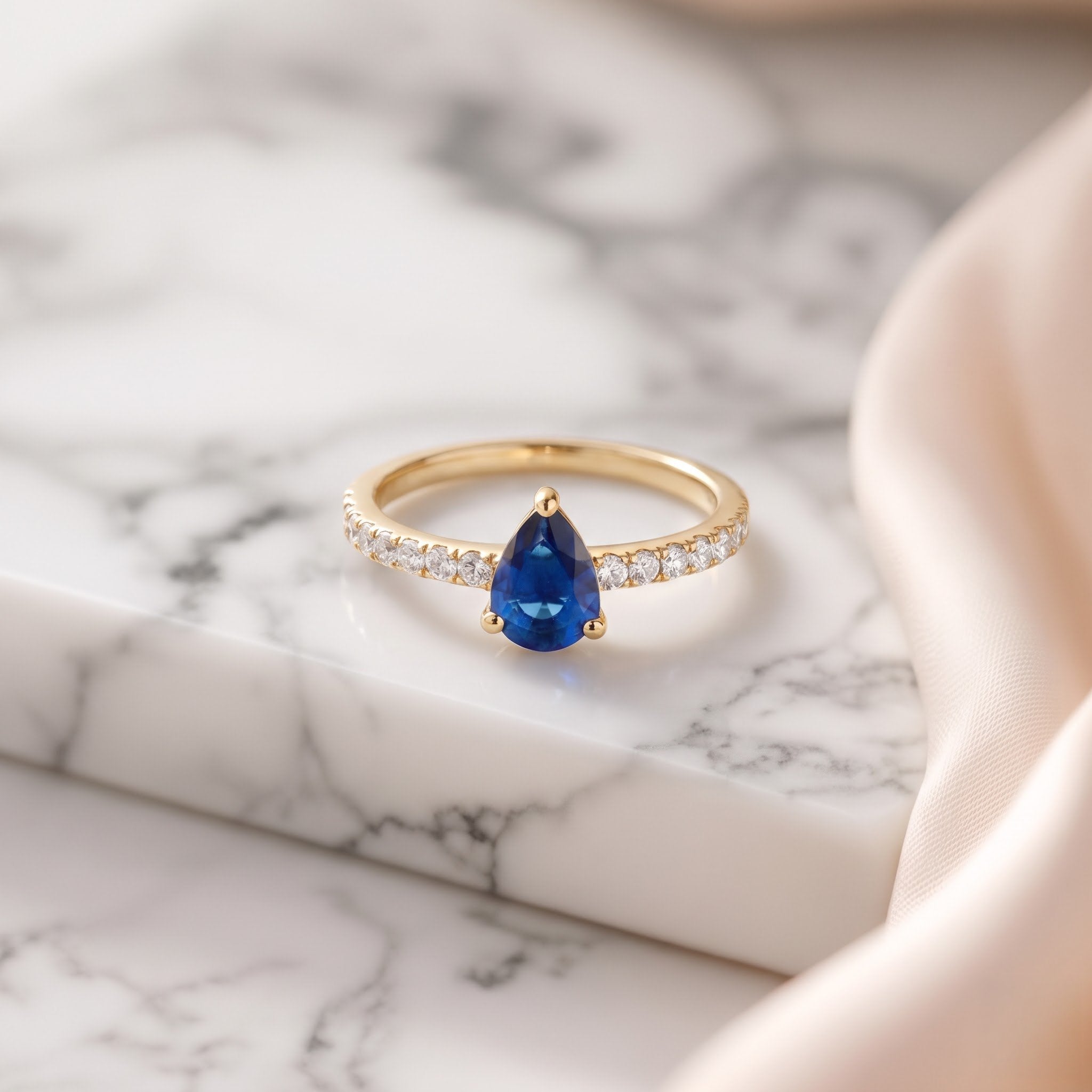 Pear Cut Blue Sapphire Ring with Pavé Band
